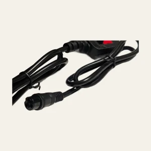 Close view of charger cable and round three-pin connector