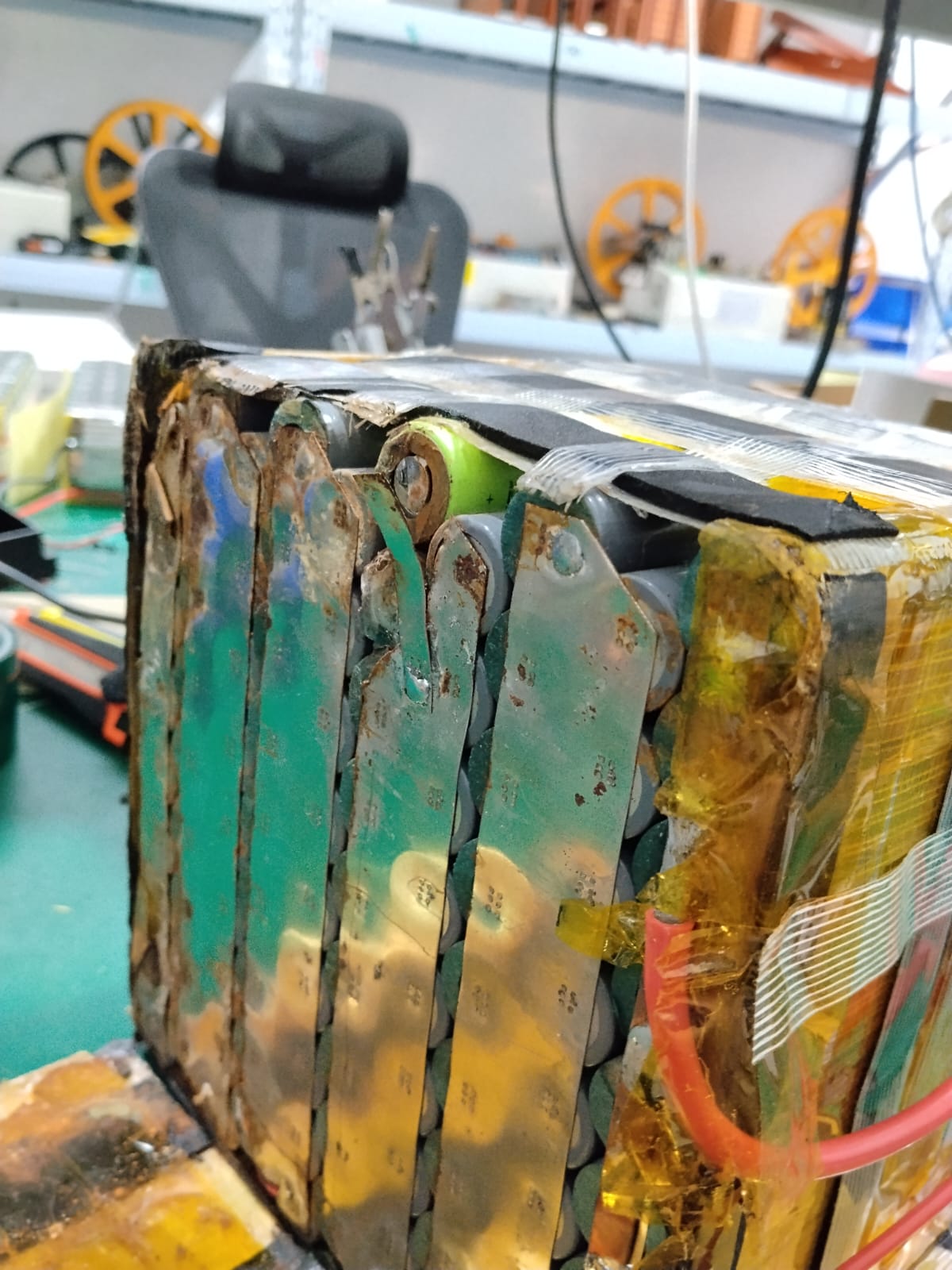 Close-up of corroded and damaged lithium battery cell connections