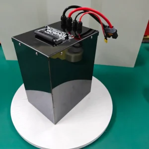 Example tall black rectangular battery case with top handle and heavy red and black leads on a turntable.
