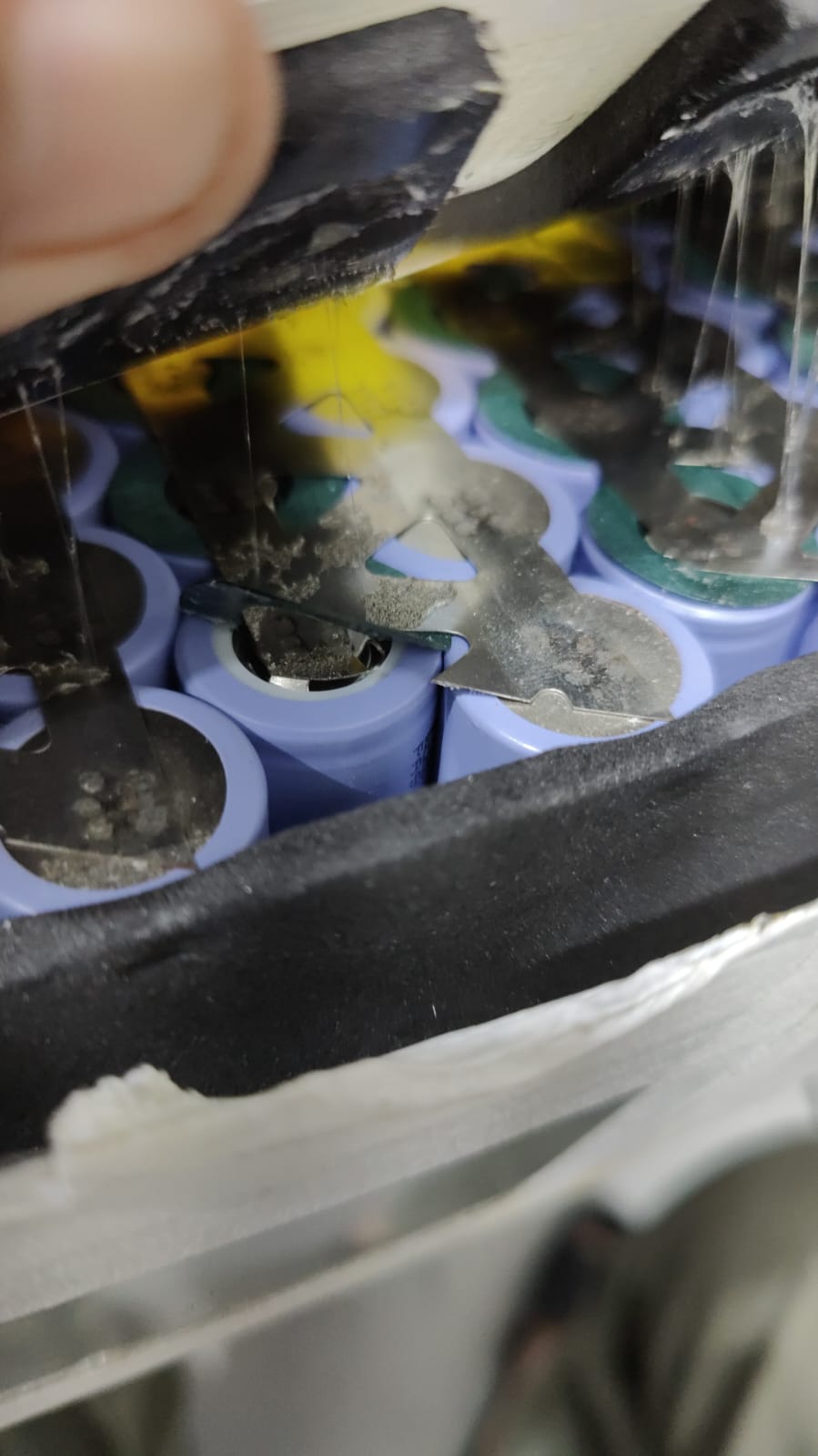 Damaged lithium cell interconnect and insulation inside an e-bike battery