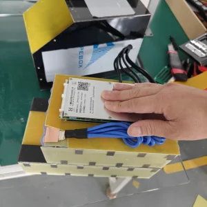 Open EM5 battery assembly with a protection board, blue wires and insulation.