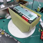BMS wiring routed on an FR-4 wrapped pack, ready for its case