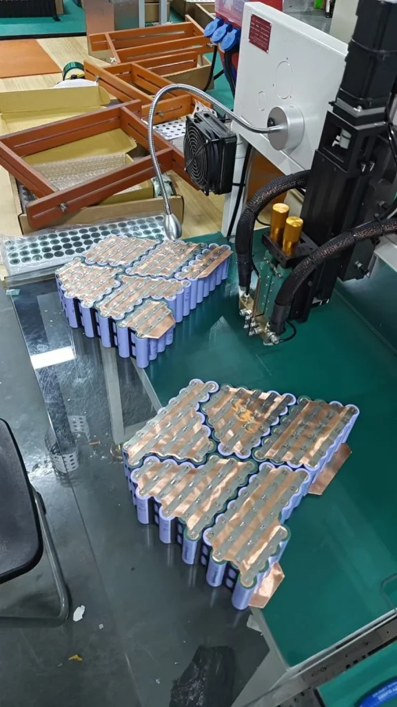 Modules under the spot welder.