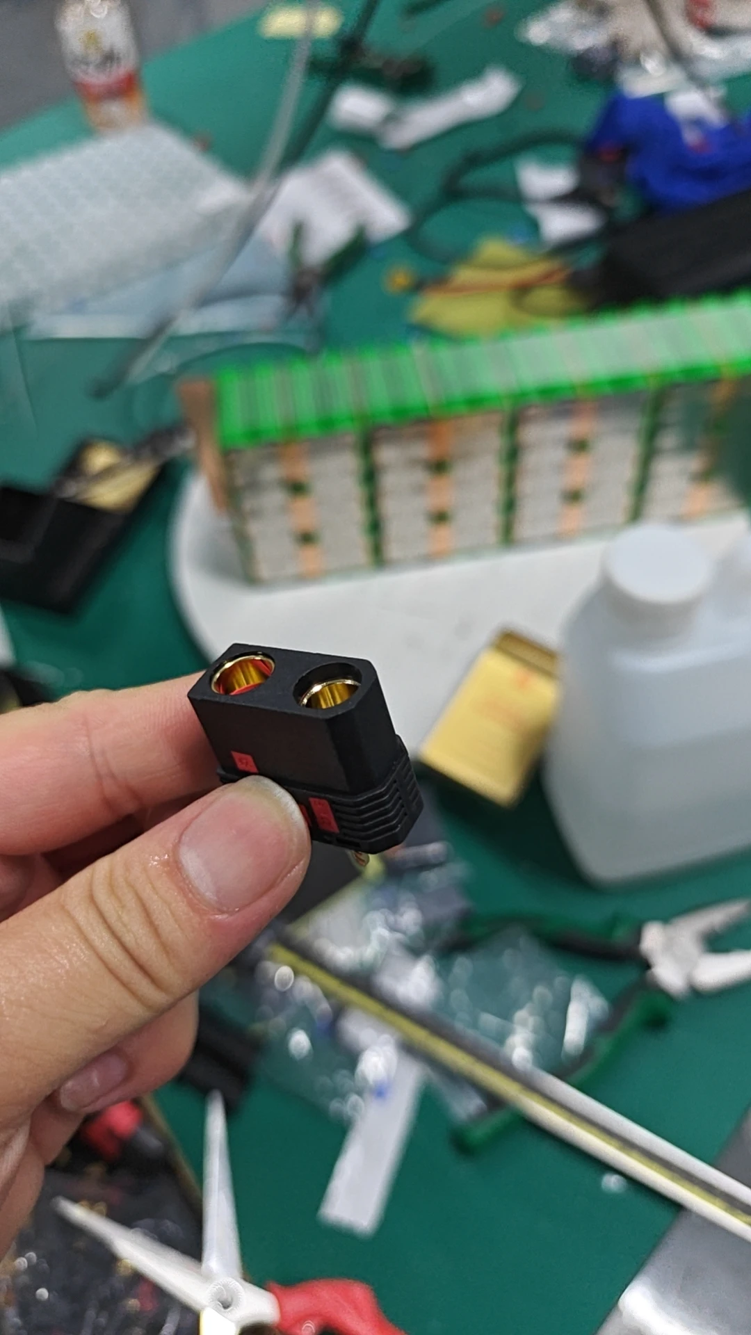 Black two-contact battery connector held close to the camera.