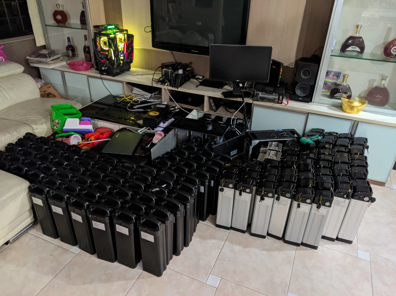 Rows of black and silver battery cases arranged together indoors.