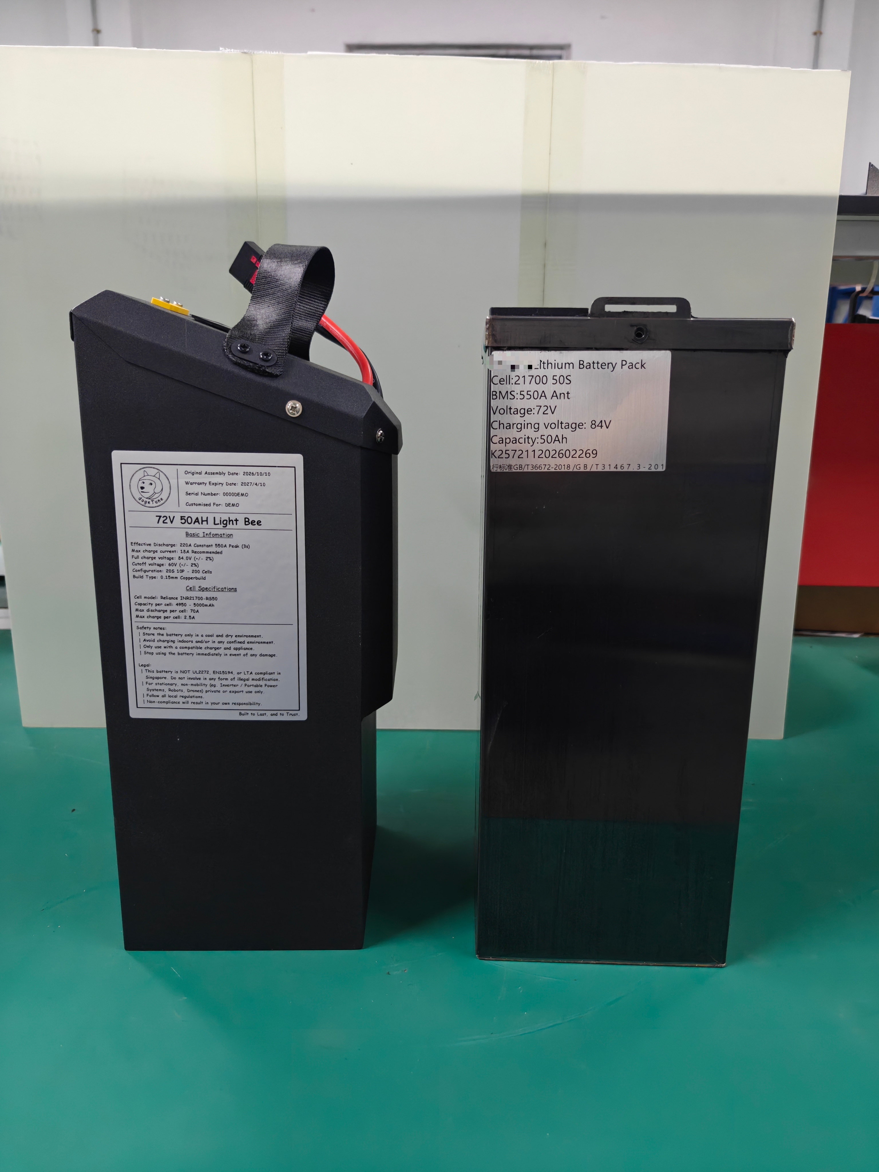 DogeTune angled Light Bee battery beside a rectangular competitor pack; both labels read72V50Ah