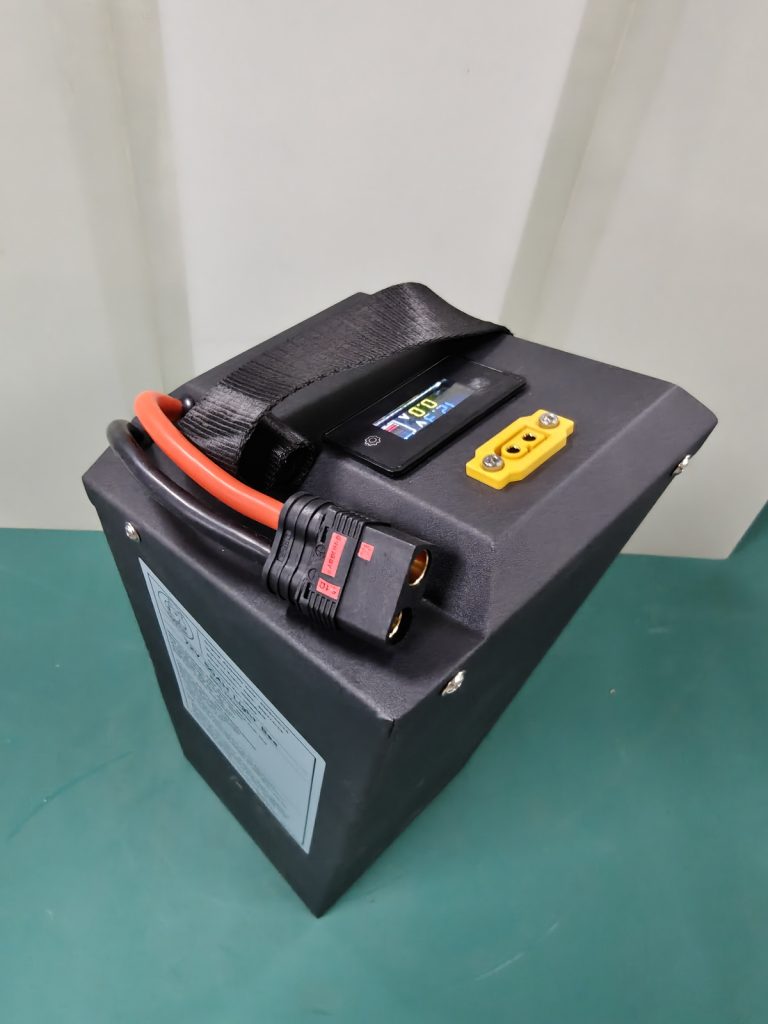 Top view of the DogeTune Light Bee battery showing its display and ports