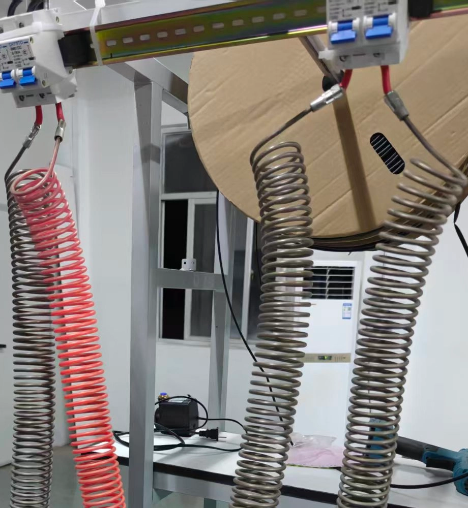 Load bank of coiled heating elements hung from breakers; one coil glows red while taking current from a battery.