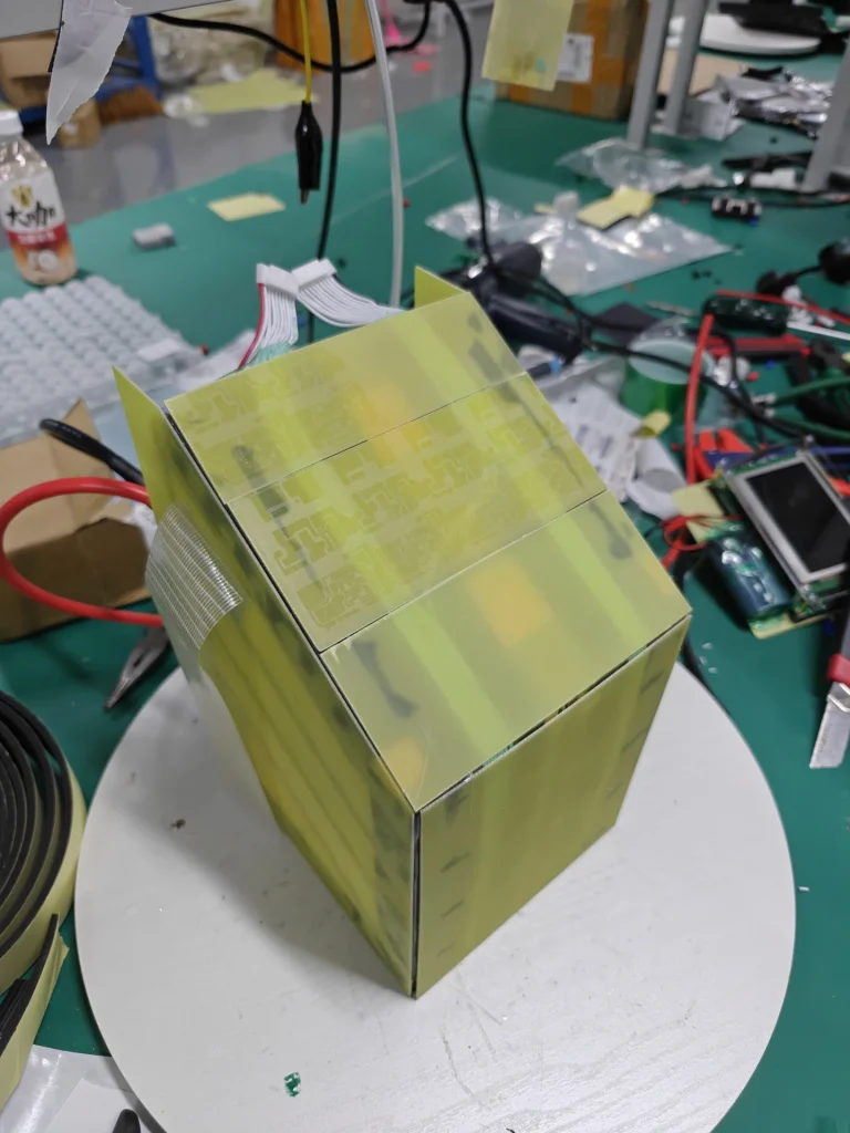 The Razor pack wrapped in yellow FR-4 with its balance leads out, on a turntable