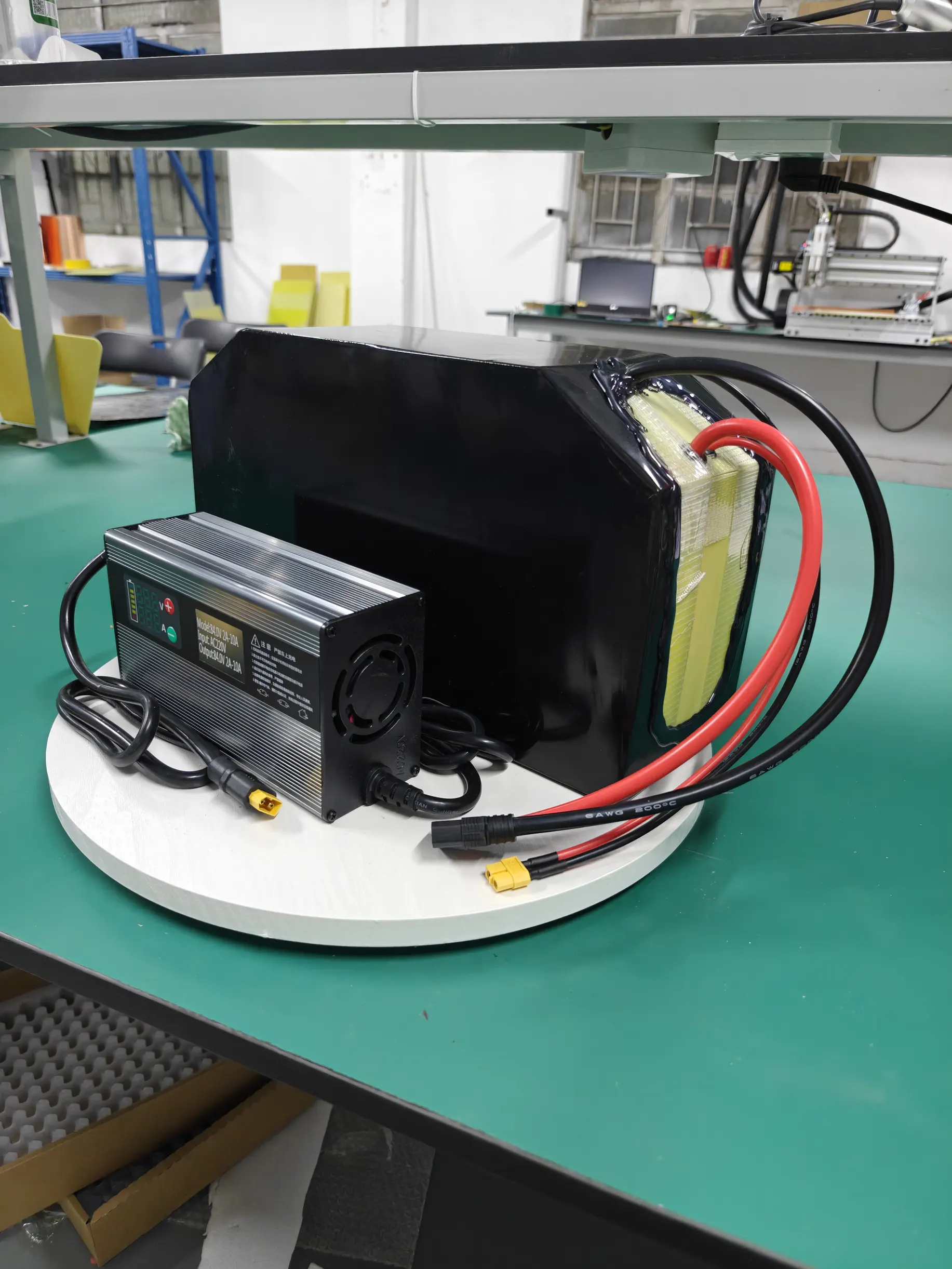 A battery assembly and charger pictured together at the workshop.