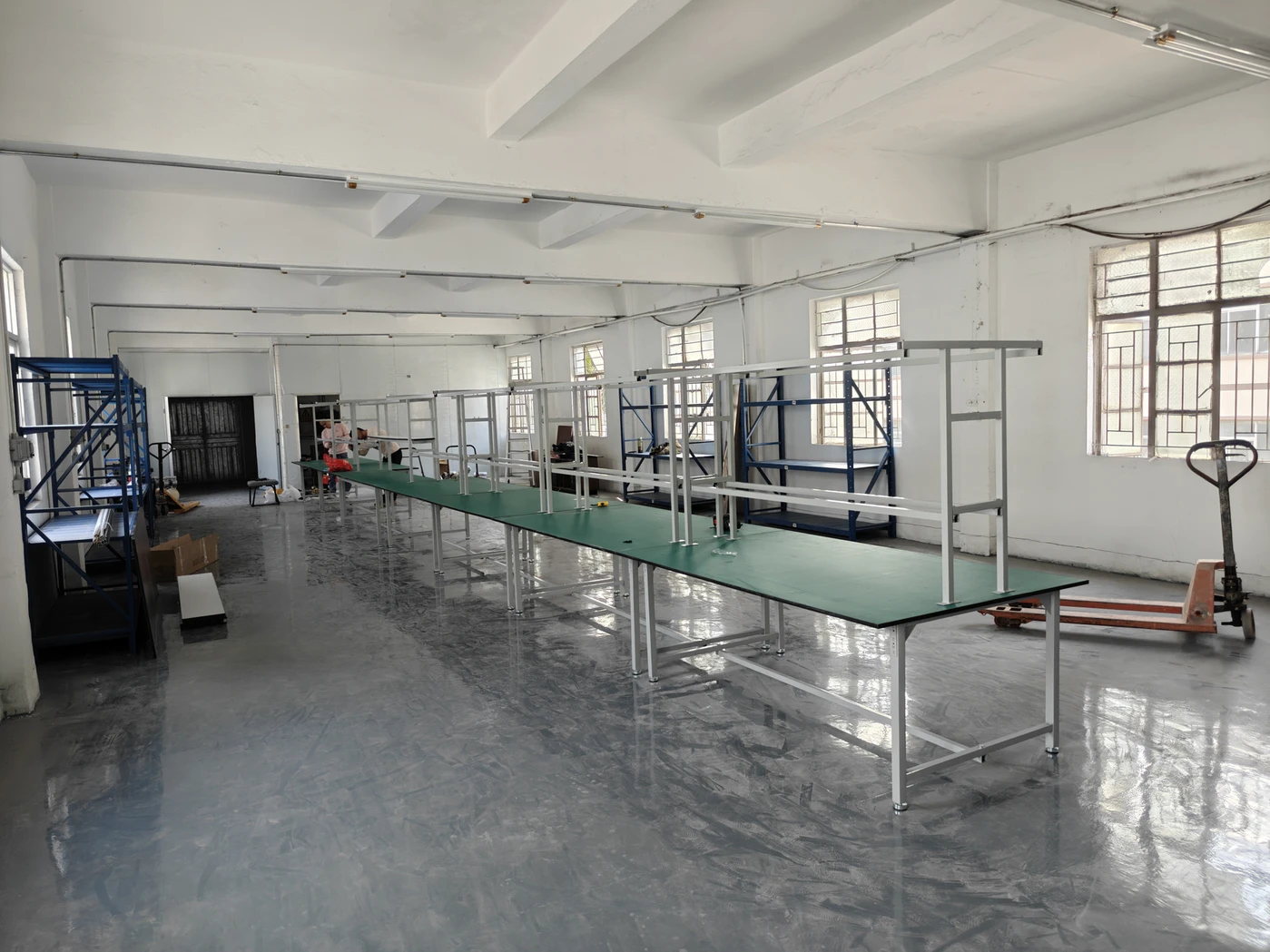 Assembly benches and storage racks inside the Huizhou workshop.