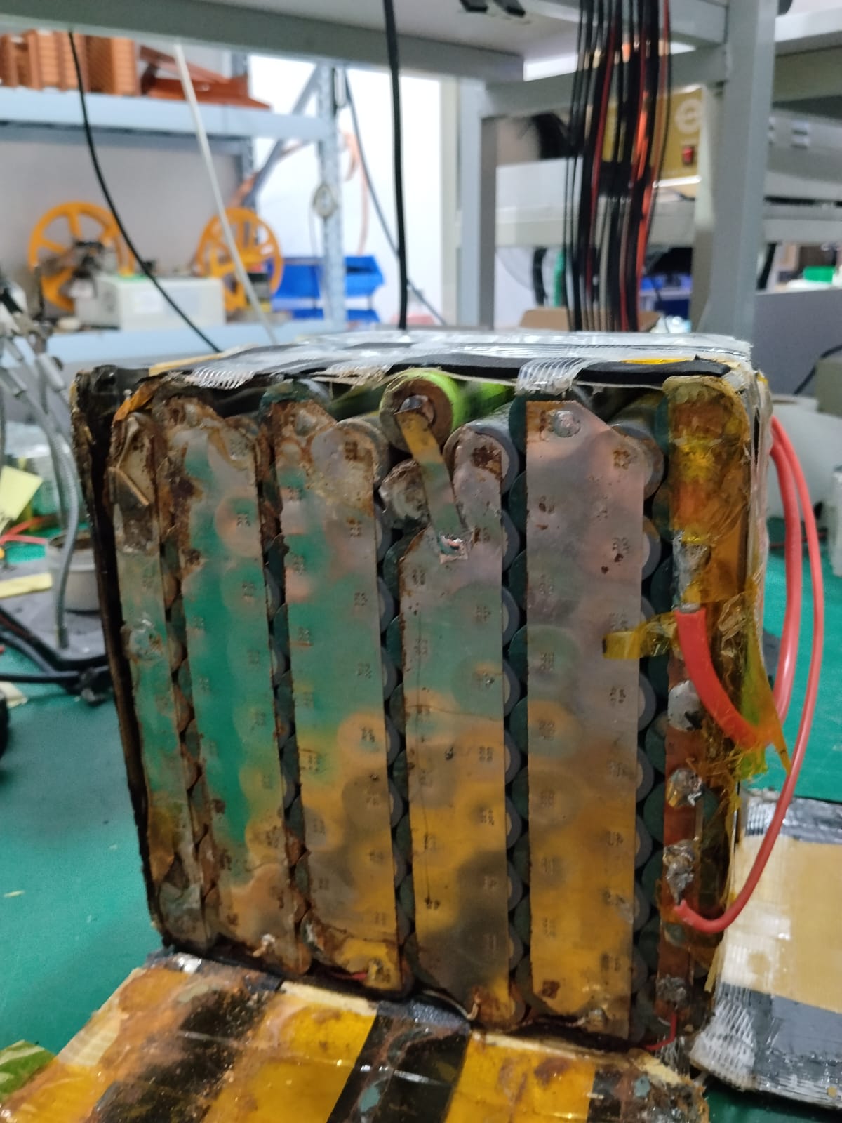 Severely corroded lithium battery cells and interconnects inside an opened pack