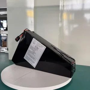 Triangular finished battery at an oblique angle showing its depth and original label