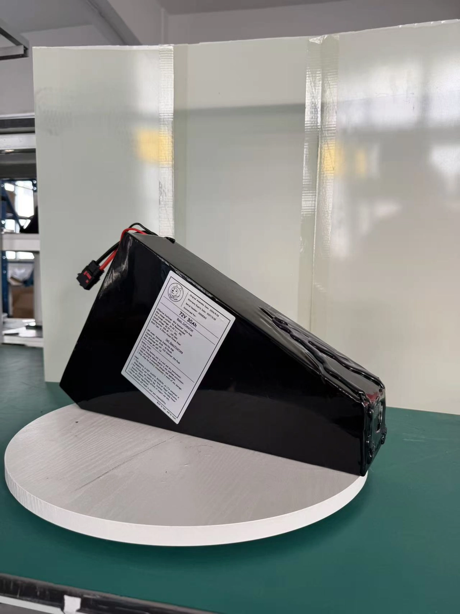 Triangular finished battery at an oblique angle showing its depth and original label