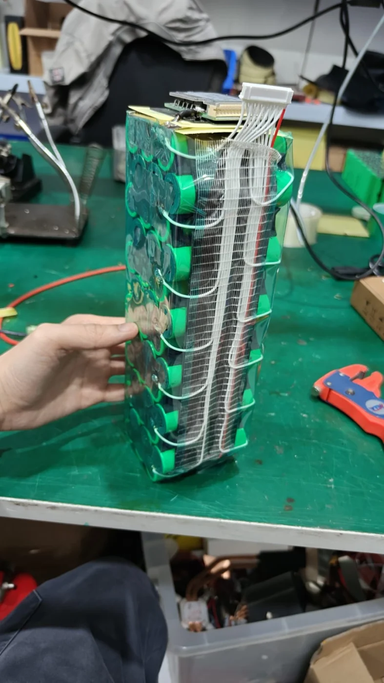 Balance wires routed along a battery pack beneath reinforced tape